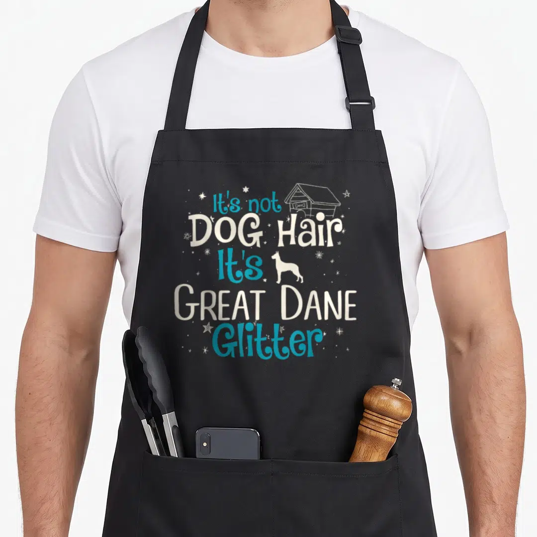 Hair dane dog apron - Stacked blue and white text reading It's not DOG Hair It's GREAT DANE Glitter with a dog house — shown on a black cotton canvas apron against a white background