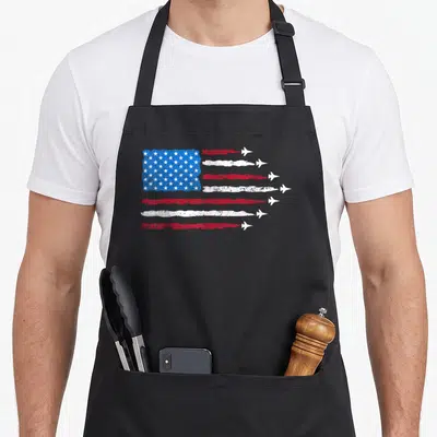 Patriotic blue 4th of july apron - Distressed USA flag with red and white stripes ending in white jet planes on a blue — shown on a black cotton canvas apron against a white background