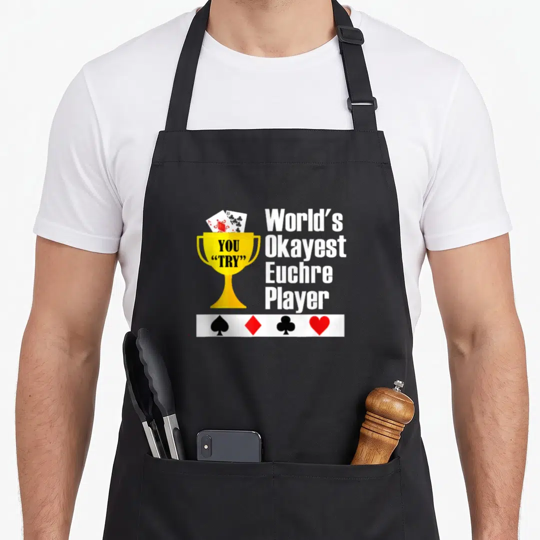 Okayest game aprons - Gold trophy with cards and text World's Okayest Euchre Player with suit symbols — shown on a black cotton canvas apron against a white background