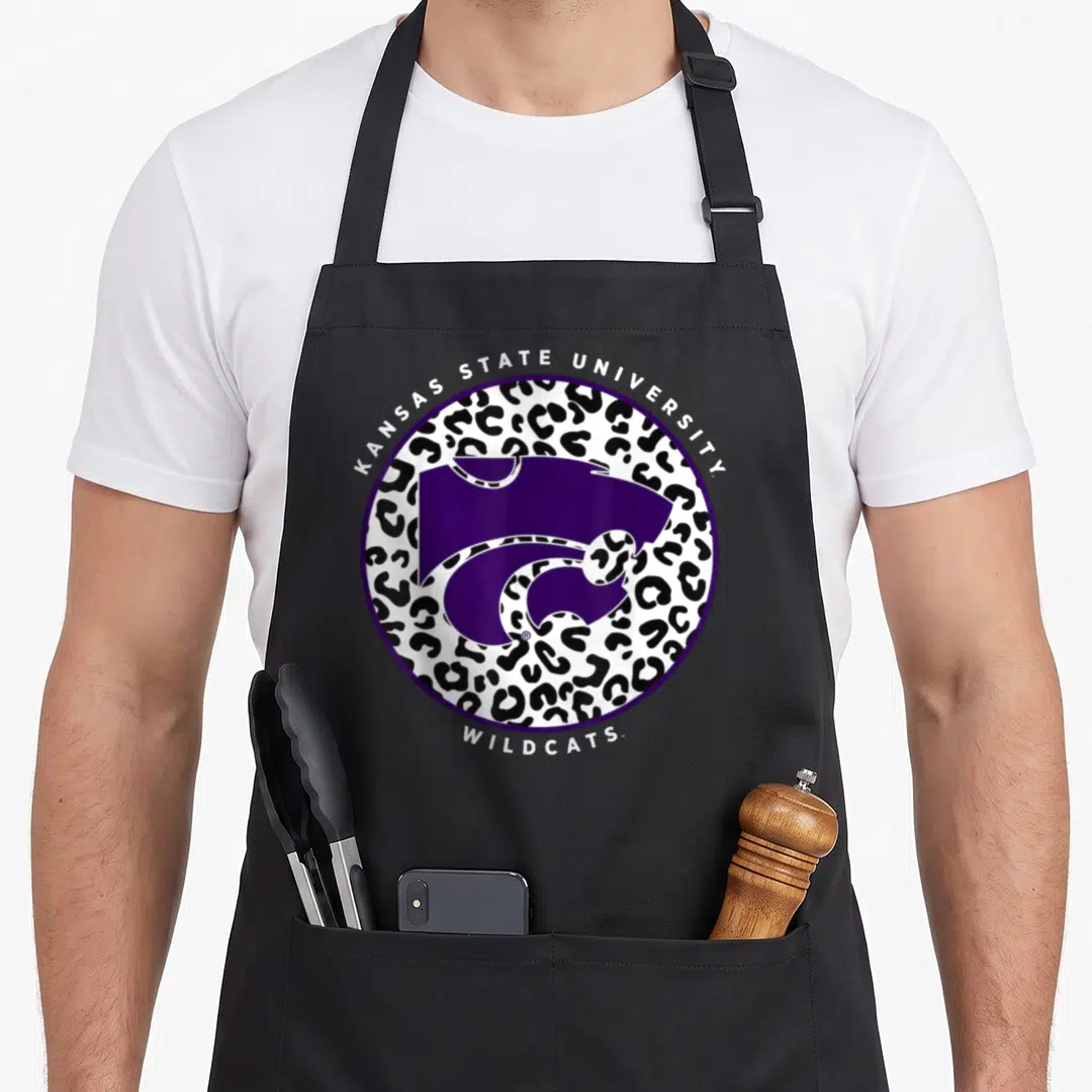 Mmkst08 kennesaw state apron - Purple wildcat head inside black and white leopard print circle with arched text — shown on a black cotton canvas apron against a white background