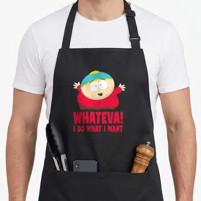 Cartman southern apron - Eric Cartman cartoon figure in red shirt and blue hat above red Whateva text — shown on a black cotton canvas apron against a white background