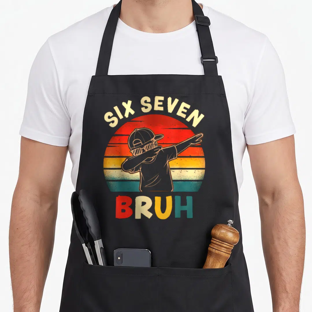 Dabbing six meme apron - Retro sunset with dabbing person, SIX SEVEN BRUH text in red orange yellow teal — shown on a black cotton canvas apron against a white background