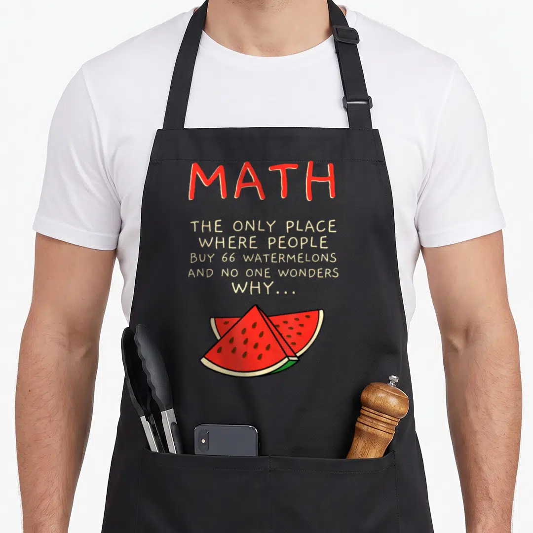 Math watermelon apron - Red MATH text and beige quote above two overlapping watermelon slices — shown on a black cotton canvas apron against a white background