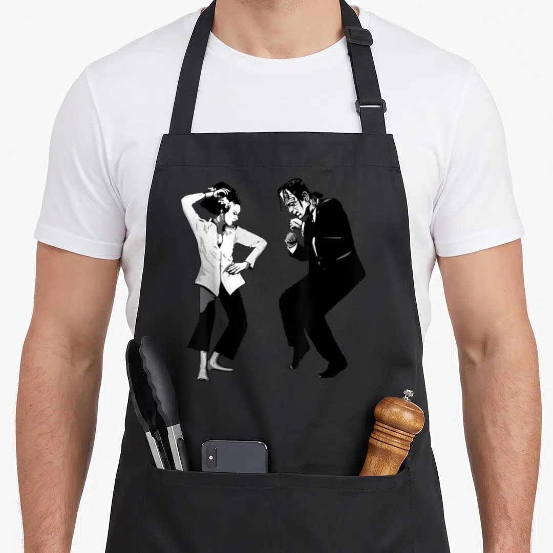Bride halloween apron - Black and white line art of Frankenstein and Bride dancing side-by-side — shown on a black cotton canvas apron against a white background
