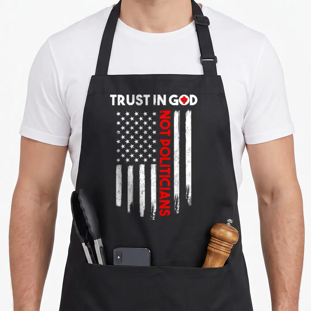Politician american flag apron - Distressed white stars and stripes with vertical red text and a red cross replacing — shown on a black cotton canvas apron against a white background