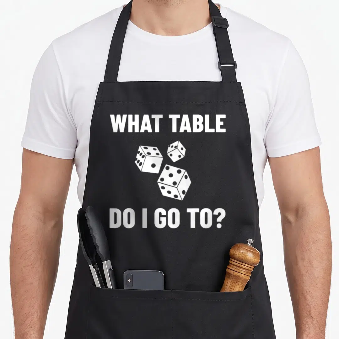 Bunco dice game aprons - White dice cluster with text WHAT TABLE DO I GO — shown on a black cotton canvas apron against a white background