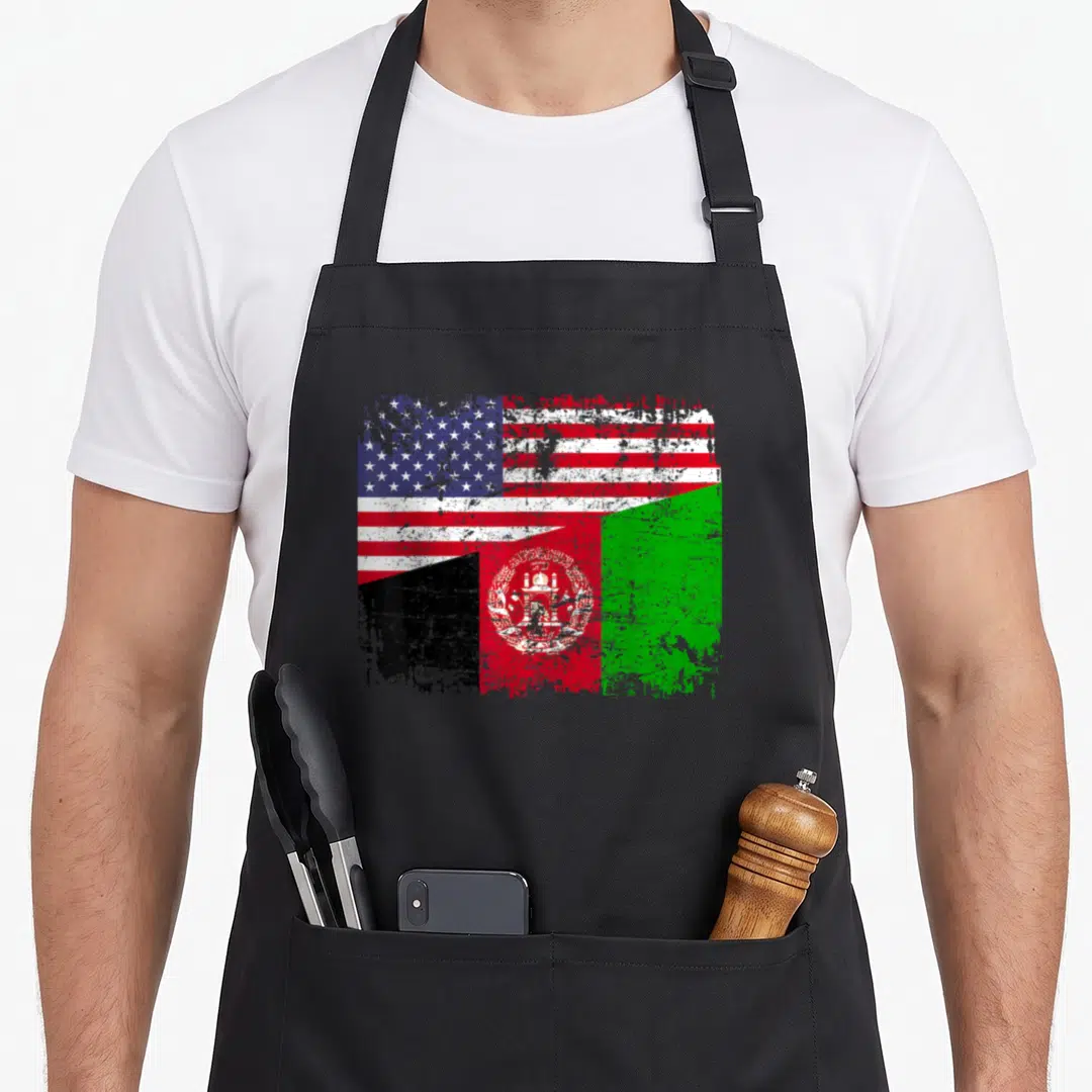 Afghan root american flag apron - Merged distressed USA and Afghanistan flags in red white blue black and green — shown on a black cotton canvas apron against a white background