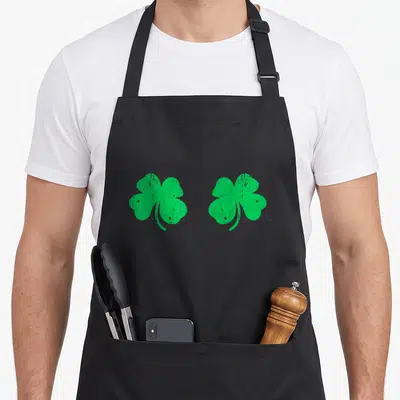 Booby irish aprons - Two green distressed shamrocks arranged horizontally on black fabric — shown on a black cotton canvas apron against a white background