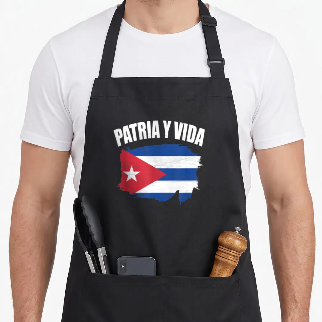 Vida viva cuba libre apron - Arched PATRIA Y VIDA text above a distressed blue white and red Cuban flag brush stroke — shown on a black cotton canvas apron against a white background
