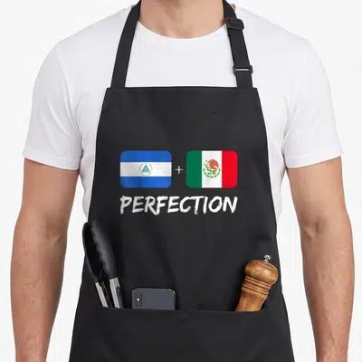 Nicaraguan mexican apron - Two flags with plus sign and PERFECTION text in blue white green and red — shown on a black cotton canvas apron against a white background