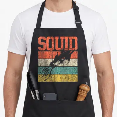 Octopus squid apron - SOLID text above grey bird silhouette over orange beige teal and yellow stripes — shown on a black cotton canvas apron against a white background