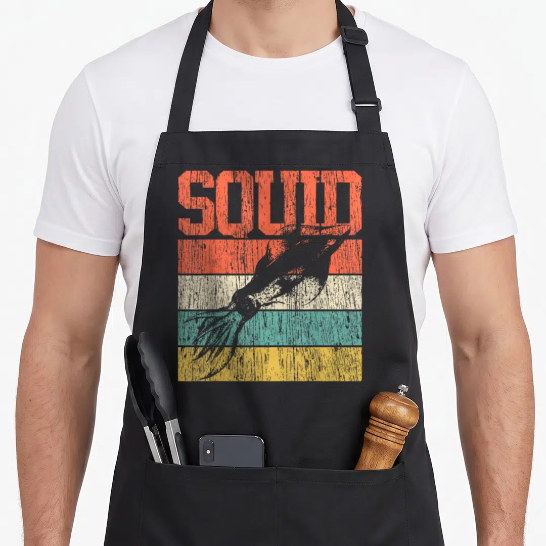 Octopus squid apron - SOLID text above grey bird silhouette over orange beige teal and yellow stripes — shown on a black cotton canvas apron against a white background
