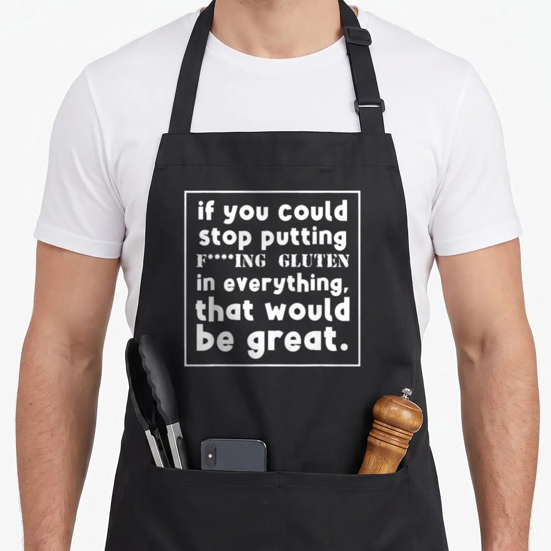 Awareness food aprons - White text inside a square border reading if you could stop putting gluten in everything that — shown on a black cotton canvas apron against a white background