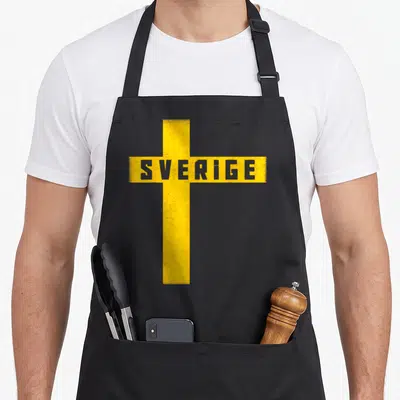Sverige scandinavian aprons - Distressed yellow cross with grey SVERIGE text on dark background — shown on a black cotton canvas apron against a white background