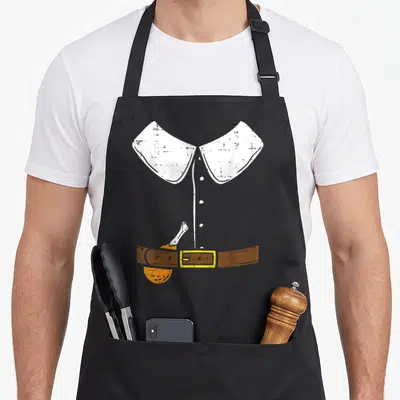 Halloween pilgrim apron - Minimalist white collared shirt with brown belt yellow buckle and orange pocket illustration — shown on a black cotton canvas apron against a white background