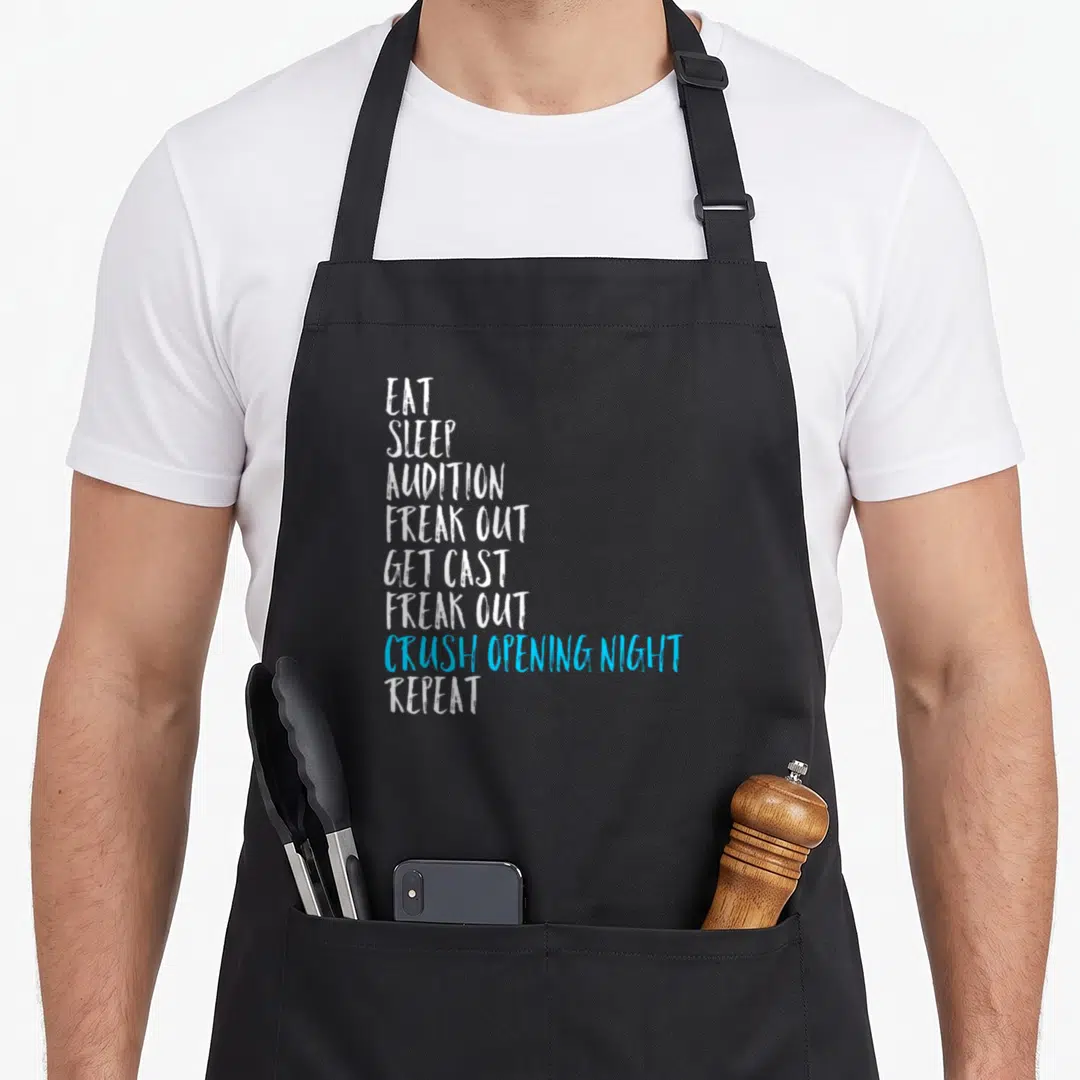 Sleep theater apron - Stacked white and blue text reading Eat Sleep Audition Freak Out Get Cast Crush Opening Night — shown on a black cotton canvas apron against a white background