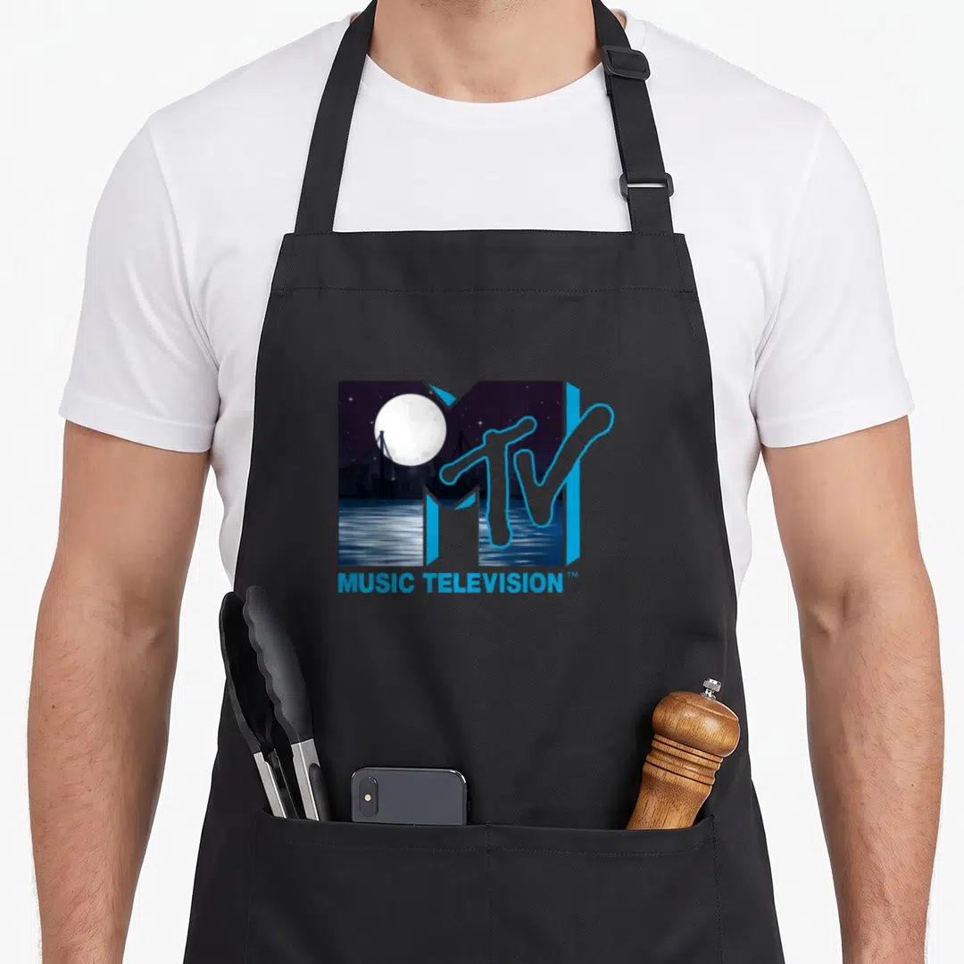 Original over officially apron - MTV logo framing a night scene with a full moon, bridge, and water in blue and white — shown on a black cotton canvas apron against a white background