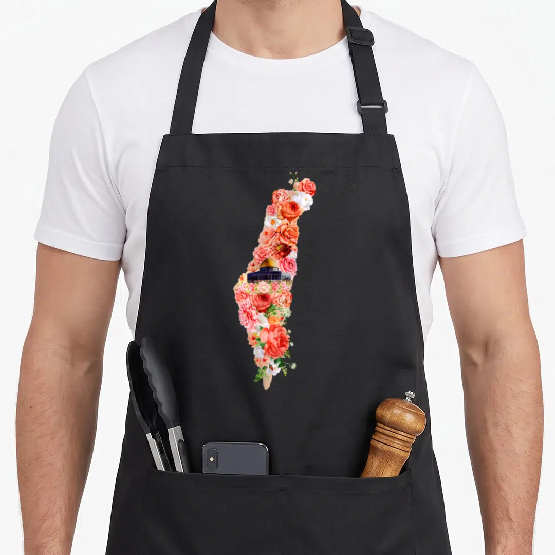 Floral palestine apron - Illinois silhouette filled with colorful roses and Illinois State Capitol building — shown on a black cotton canvas apron against a white background