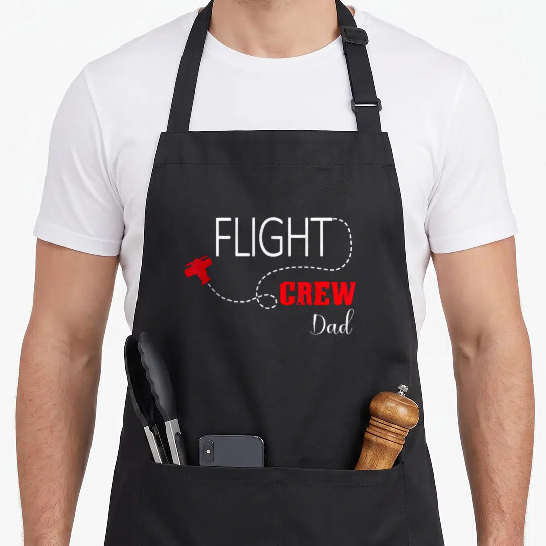 Crew airplane apron - Red cartoon plane with white dotted trail surrounding FLIGHT CREW Dad text — shown on a black cotton canvas apron against a white background