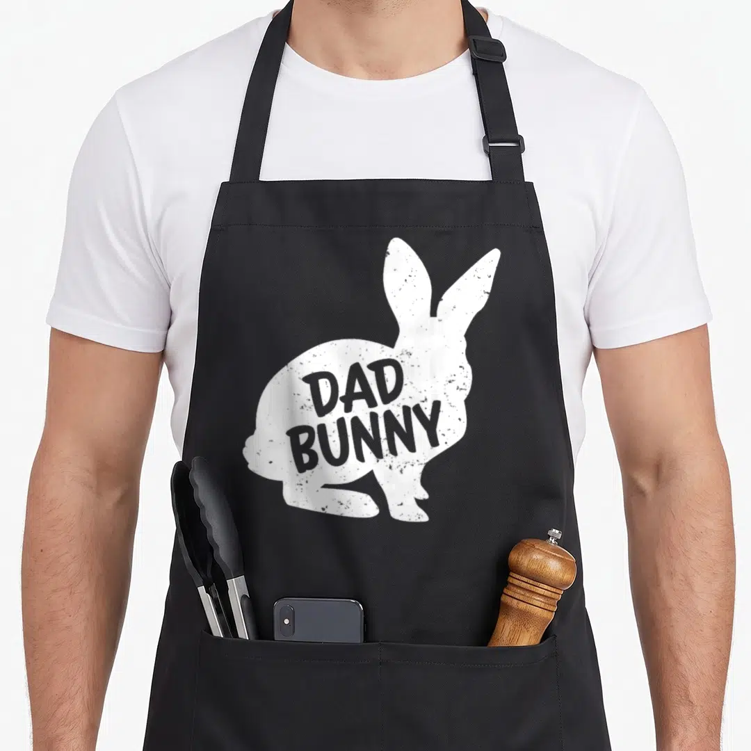 Family easter hare aprons - White distressed rabbit silhouette with Dad Bunny text inside — shown on a black cotton canvas apron against a white background