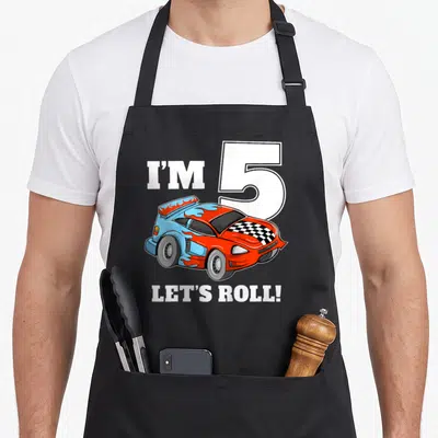 Five car apron - Red and blue race car with flames and text I'M 5 LET'S ROLL — shown on a black cotton canvas apron against a white background
