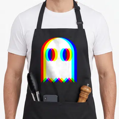 Trippy ghost apron - White ghost shape with red yellow green blue cyan magenta offset border and eyes — shown on a black cotton canvas apron against a white background