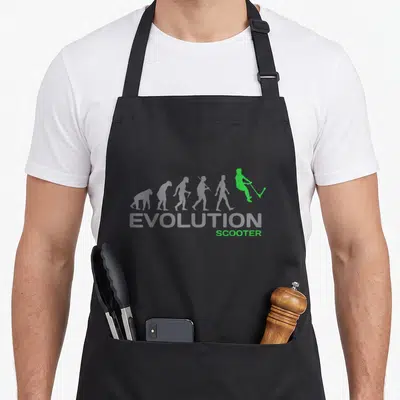 Evolution scooter apron - Grey evolution silhouettes ending in a green stunt scooter rider with text — shown on a black cotton canvas apron against a white background
