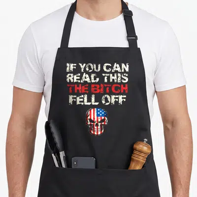 Fell novelty apron - Distressed text stack above an American flag skull in red white and blue — shown on a black cotton canvas apron against a white background