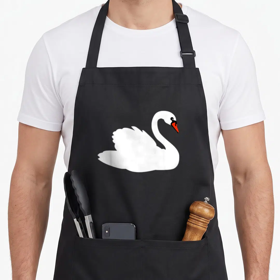 Vintage animal swan apron - Minimalist white swan with orange beak and black eye centered on grey background — shown on a black cotton canvas apron against a white background