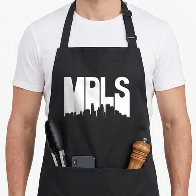 Skyline minneapolis apron - White MPLS text with Minneapolis skyline silhouette integrated into the bottom — shown on a black cotton canvas apron against a white background