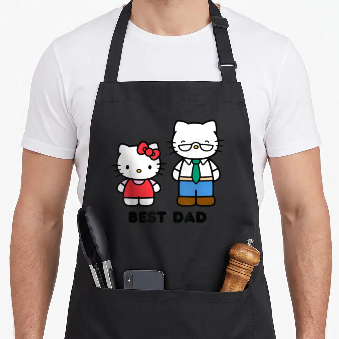 Cute father day apron - Two white cartoon cats standing side-by-side with BEST DAD text below — shown on a black cotton canvas apron against a white background