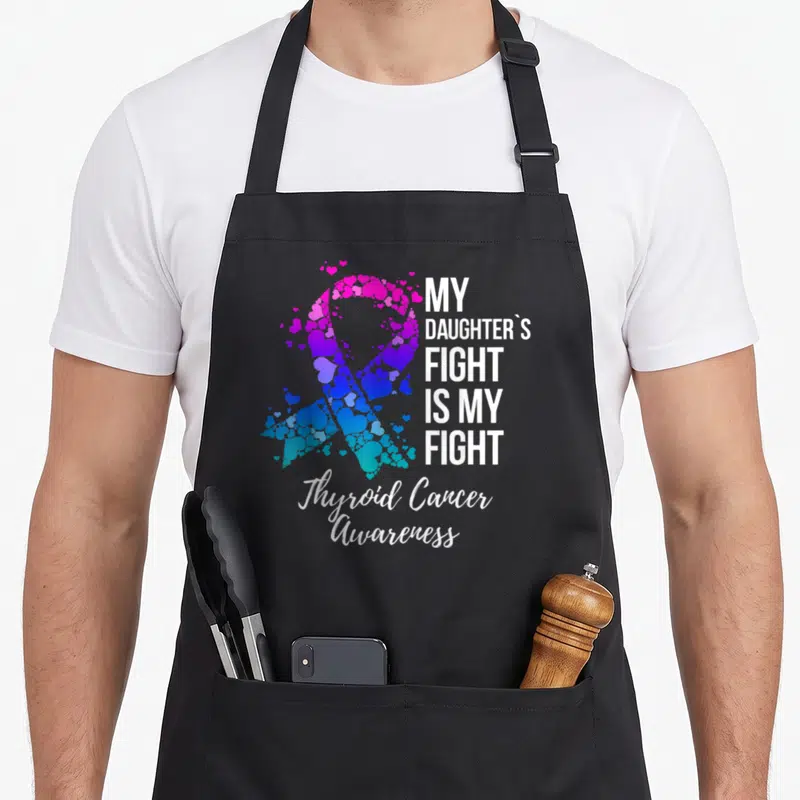 Fight thyroid apron - Heart mosaic awareness ribbon with stacked white text reading My Daughters Fight Is My Fight — shown on a black cotton canvas apron against a white background