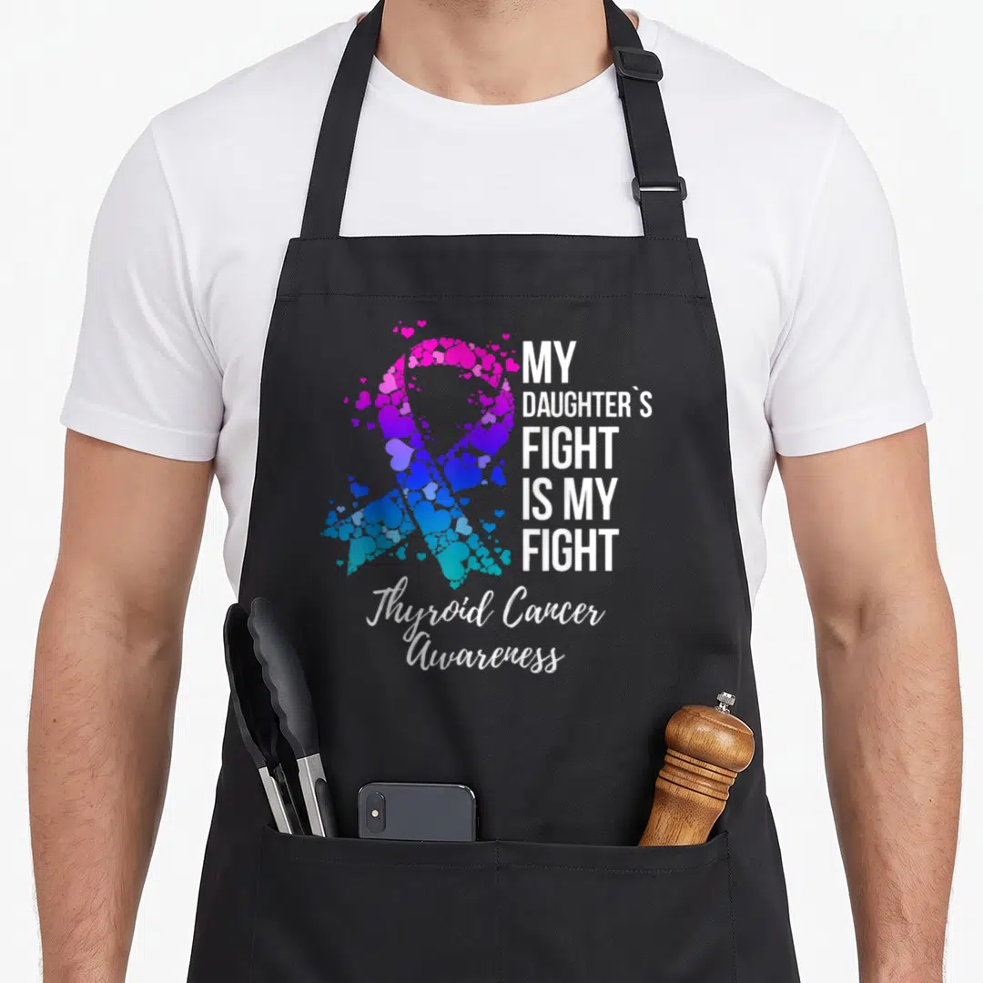 Fight thyroid apron - Heart mosaic awareness ribbon with stacked white text reading My Daughters Fight Is My Fight — shown on a black cotton canvas apron against a white background