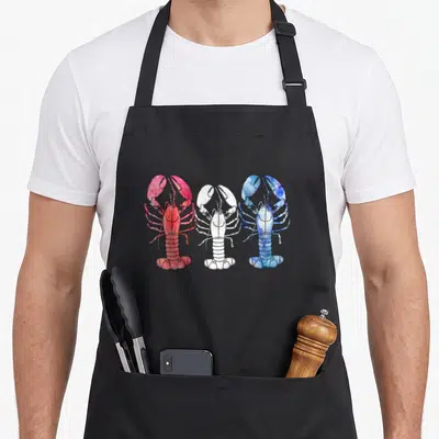 Blue lobster apron - Three watercolor lobsters in red, white, and blue horizontal row — shown on a black cotton canvas apron against a white background