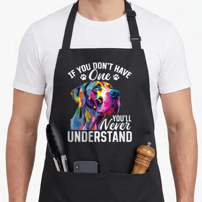 Dane dog breed aprons - Colorful cartoon Great Dane head with IF YOU DON'T HAVE One YOU'LL Never UNDERSTAND text — shown on a black cotton canvas apron against a white background