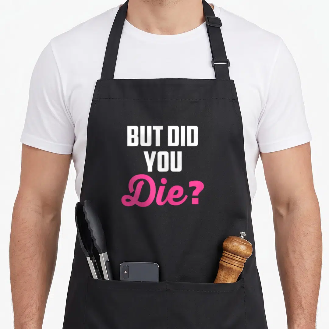 Die nurse apron - Stacked white and pink text reading BUT DID YOU Die on black fabric — shown on a black cotton canvas apron against a white background