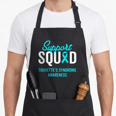 Warrior tourette awareness apron - Support Squad text with cyan ribbon replacing A and Tourette's Syndrome Awareness — shown on a black cotton canvas apron against a white background