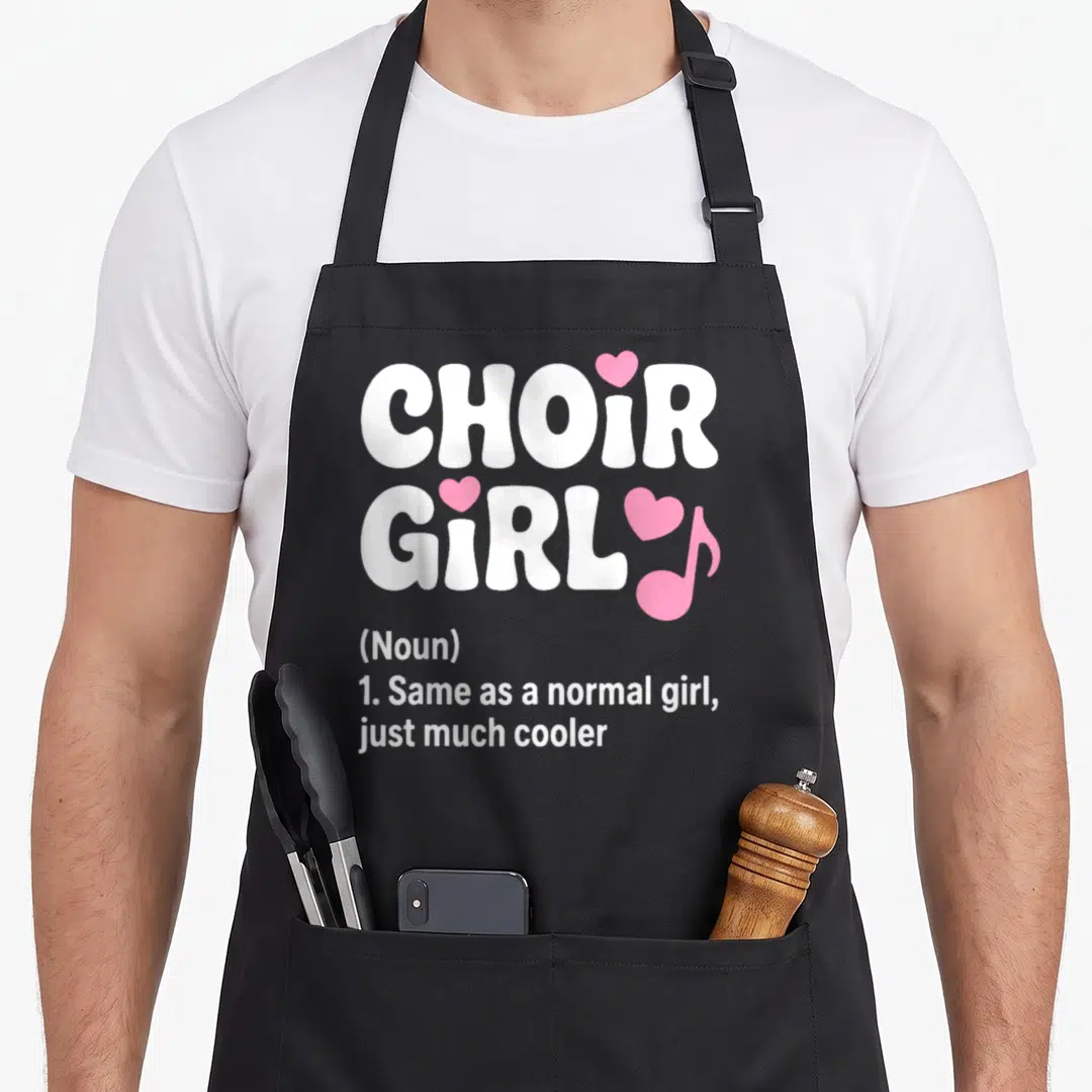 Singing chorus apron - White CHOIR GIRL text with pink hearts and musical note above dictionary definition — shown on a black cotton canvas apron against a white background