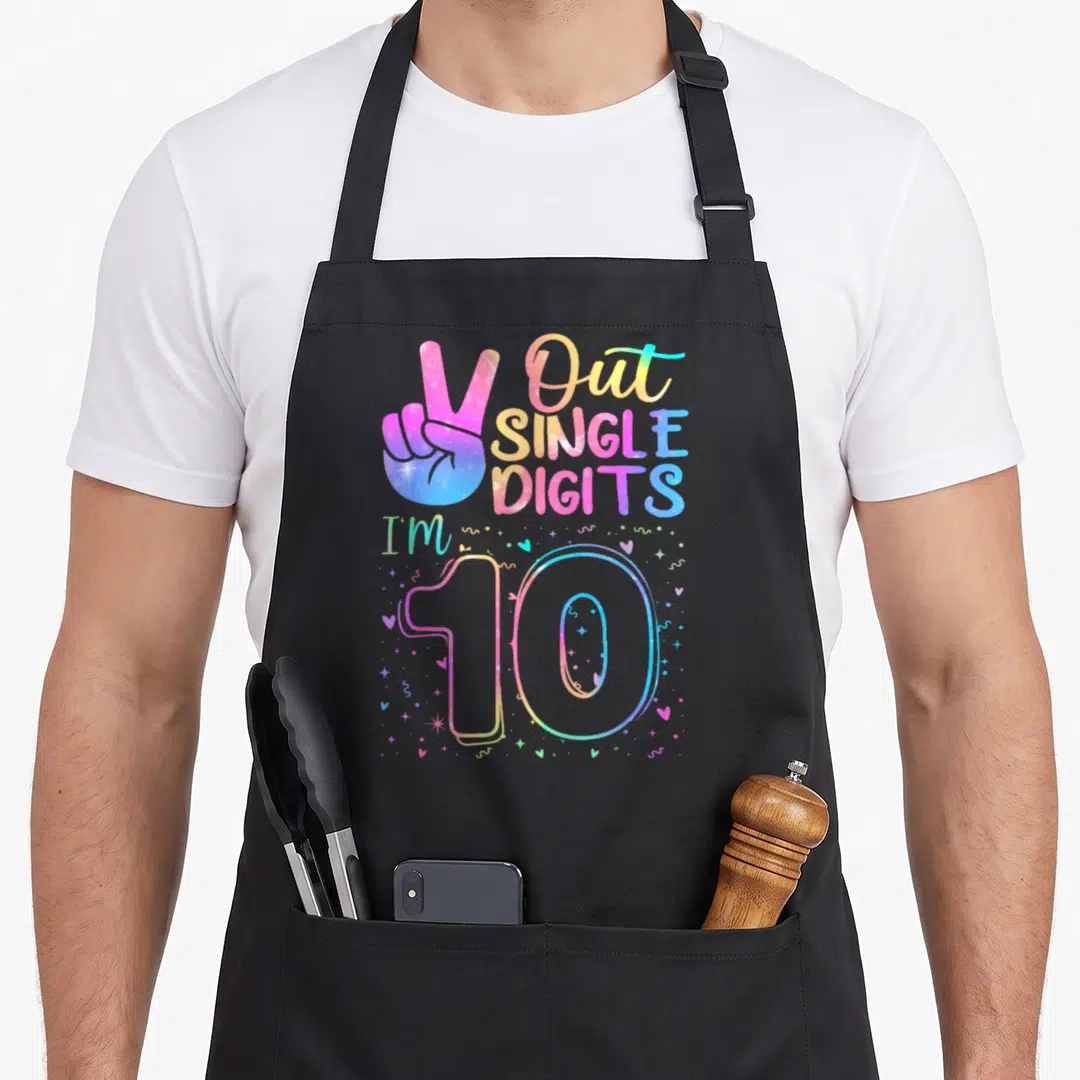 Peace single birthday apron - Rainbow peace sign hand and Out SINGLE DIGITS I'M 10 text with hearts and stars — shown on a black cotton canvas apron against a white background