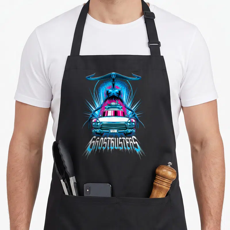Death car apron - Blue monster looming over white Ecto-1 car with GHOSTBUSTERS text — shown on a black cotton canvas apron against a white background
