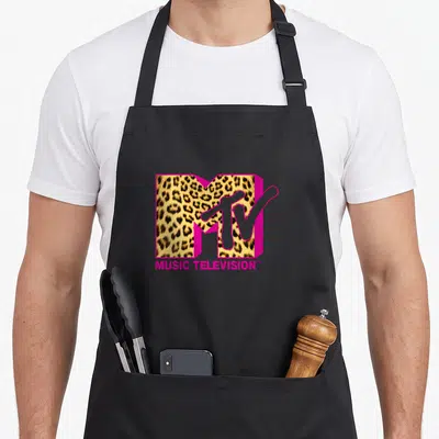 Retro mtv leopard print apron - MTV logo with leopard print fill, pink 3D block letters, MUSIC TELEVISION text below — shown on a black cotton canvas apron against a white background