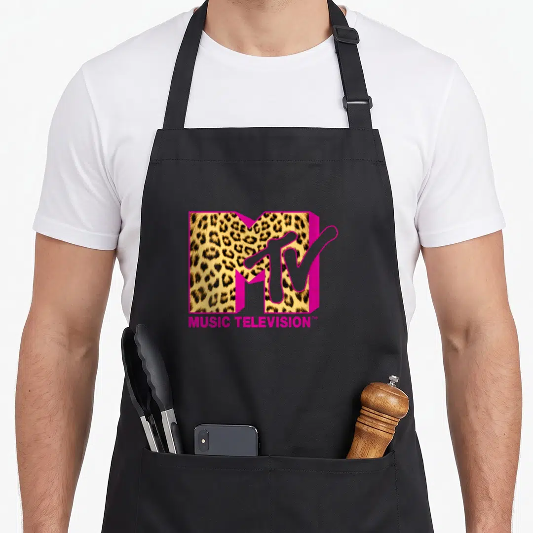 Retro mtv leopard print apron - MTV logo with leopard print fill, pink 3D block letters, MUSIC TELEVISION text below — shown on a black cotton canvas apron against a white background