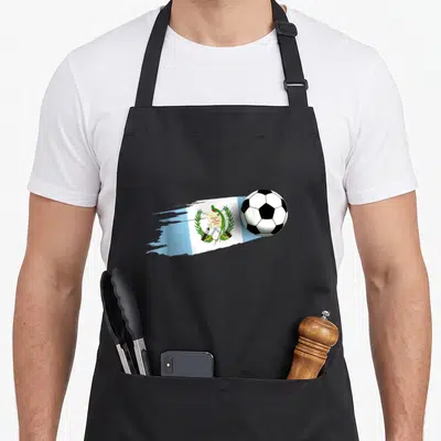 Cute guatemala guatemalan aprons - Soccer ball overlapping brush-stroke Guatemalan flag with liberty text — shown on a black cotton canvas apron against a white background