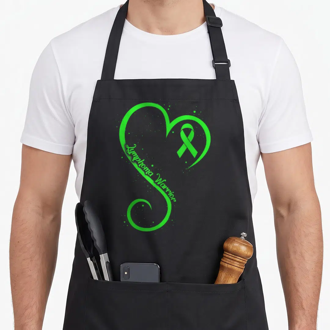 Lymphoma lime green apron - Green heart outline containing awareness ribbon and scattered dots — shown on a black cotton canvas apron against a white background