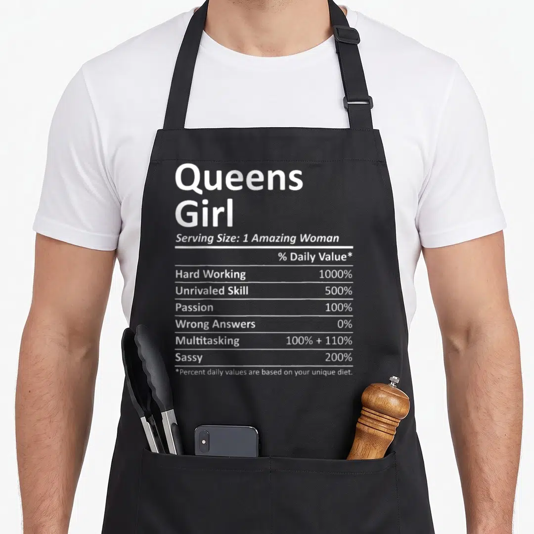 Queen root new york aprons - White nutrition label typography listing 1000 percent hard working and 200 percent sassy — shown on a black cotton canvas apron against a white background