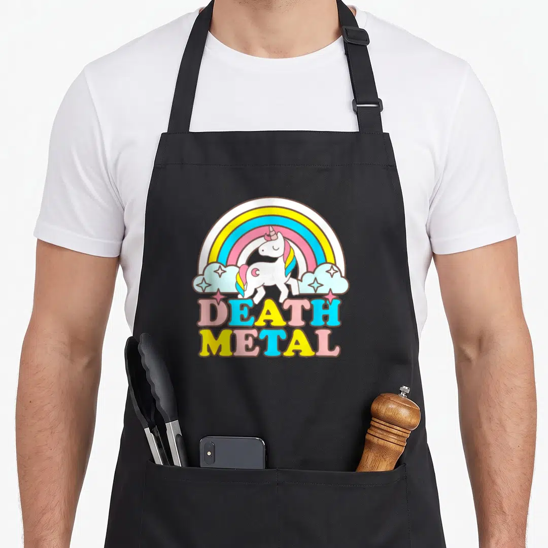 Metal rainbow apron - Cartoon unicorn under rainbow with multi-colored DEATH METAL text — shown on a black cotton canvas apron against a white background