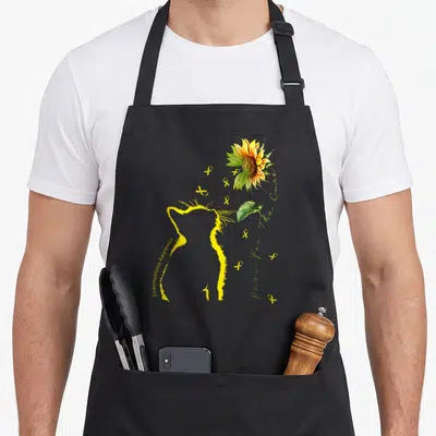 Cure cat apron - Yellow cat outline with sunflower and awareness ribbons — shown on a black cotton canvas apron against a white background