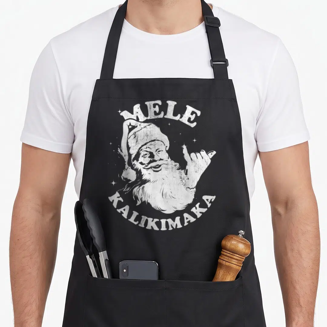 Surf christmas santa apron - White distressed Santa making shaka sign with Mele Kalikimaka text and stars — shown on a black cotton canvas apron against a white background