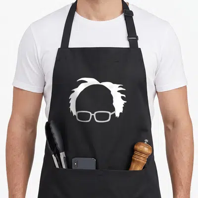 Bernie hair apron - Minimalist white messy hair and light grey glasses silhouette on grey background — shown on a black cotton canvas apron against a white background