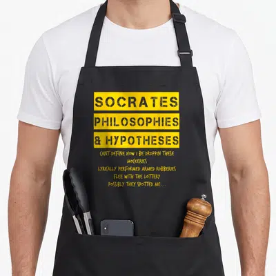 Golden hip apron - Yellow and grey typography reading Socrates Philosophies Hypotheses with rap lyrics below — shown on a black cotton canvas apron against a white background